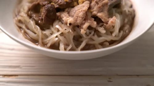 Close Up Delicious Asian Noodles with Meat and Vegetables