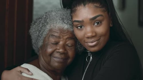 Loving Grandmother and Young Adult Embrace Affectionately