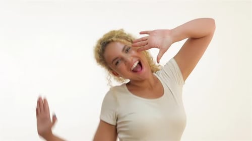 Woman Dancing and Smiling on White Background