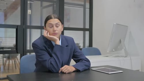 Tired Hispanic Businesswoman Sleeping in Office