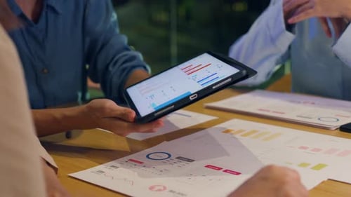 Asia businesspeople meeting plan analysis statistics brainstorm at office night.