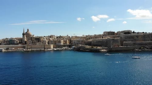 Valletta mediterranean capital city of Malta island skyline from harbour with blue sea and yacht on