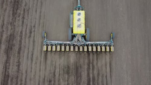 Blue tractor OA working on the field in Ukraine