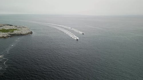 Cinematic Drone Shot of Three Boats with a Motor Floating in the Ocean