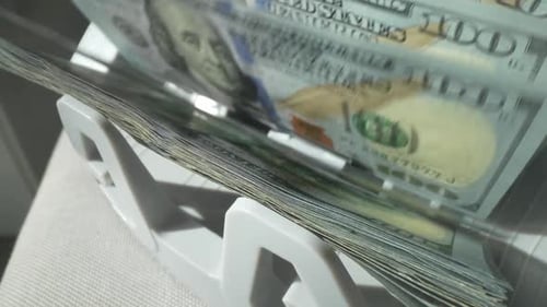 Finance and Cash Dollars Concept Counting Dollars with Electronic Money Counter Machine 100 Dollar