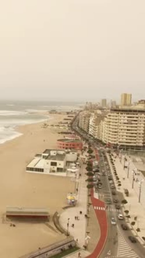 Vertical Video of Sea Waves and City Buildings Coastline