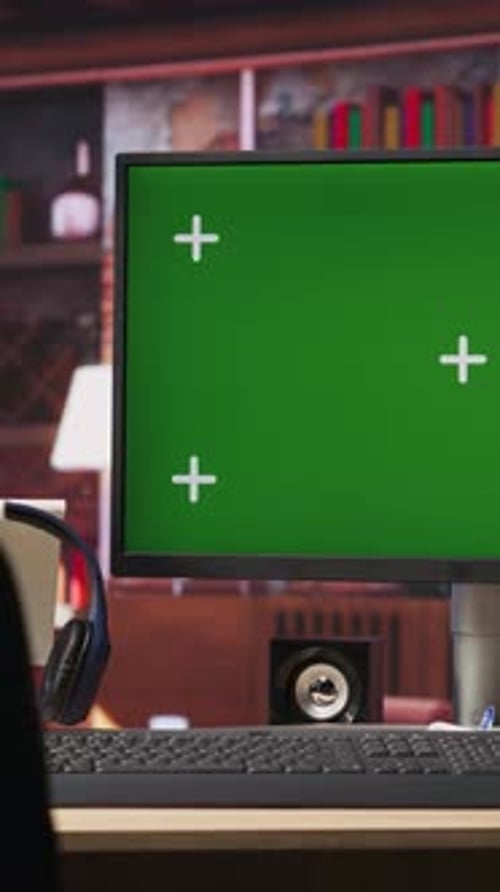 Vertical Video Green Screen Computer Monitor on Wooden Desk in Modern Home