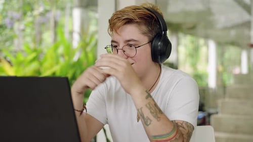 Young Adult Using Laptop for Video Call at Home