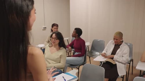 Diverse Students Laughing and Talking in University Class