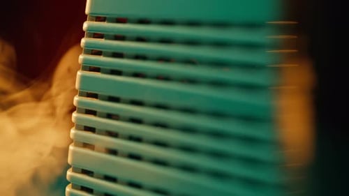 Closeup Warm Air Heater with Soft Smoke Curling Gently Nearby Indoor Warmth