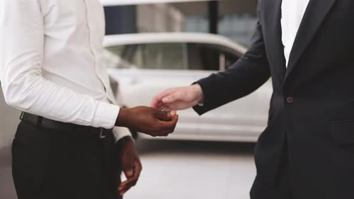 Cropped View of African Man Shaking Hand with Vehicle Seller