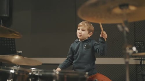 Talented Little Boy Playing Drums at Music School