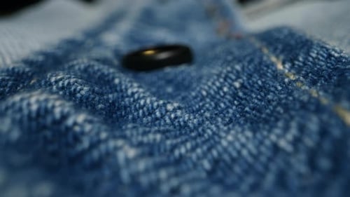 Extreme Close Up of Denim Fabric with a Ring