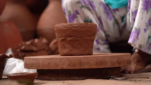 Craftsperson Molding Clay on a Pottery Wheel
