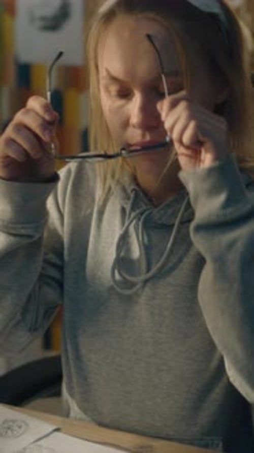 Female Artist Reviews Sketches in Creative Studio