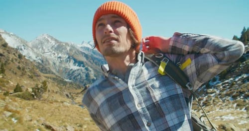 Tourist Man Puts Hiker Backpack After Break on Spring Vacation Mountain Travel