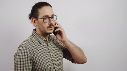 Man Talking on Smartphone Against White Background