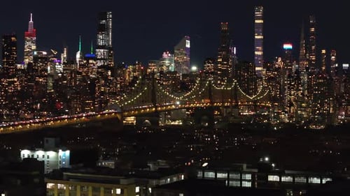 Iconic Skyline of Manhattan at Night Featuring Queensboro Bridge Connecting Queens with East Midtown
