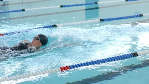 Caucasian female swimmer athlete swimming in a pool