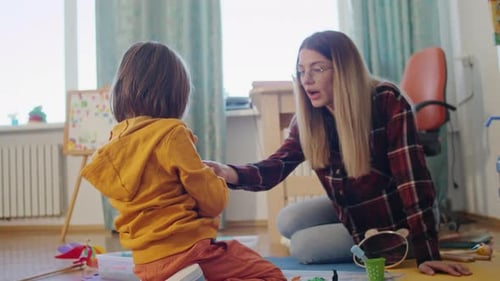 Child Interacting with an Adult in a Playroom