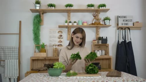 Woman Preparing Green Vegetables in Sunny Kitchen