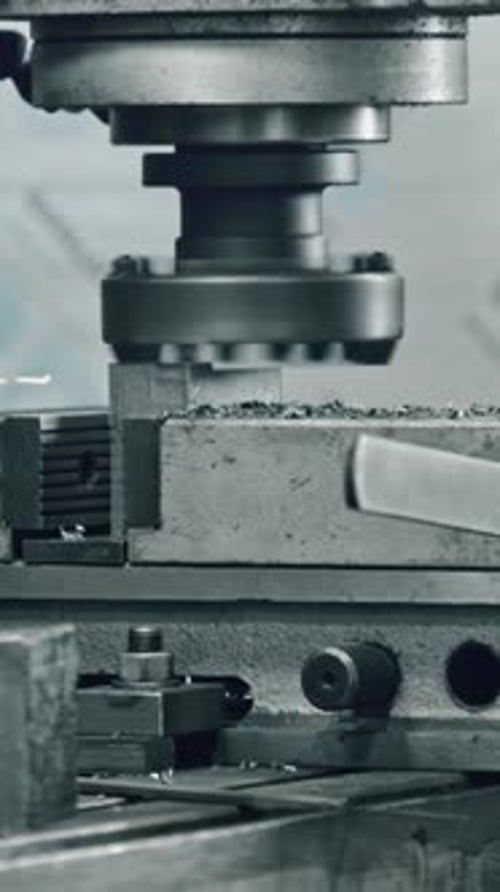 Precision metal cutting machine sparks in industrial workshop