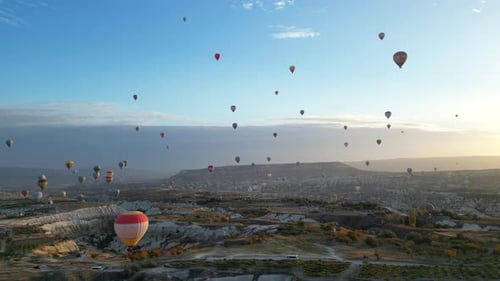 Hot Air Balloons Floating Over Scenic Landscape