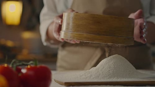 DIY spaghetti, chef in action Sifting flour with a wheat flour sieve In specialized pasta restaurant
