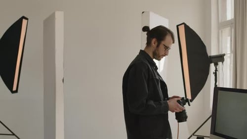 Young Photographer Working in Professional Studio