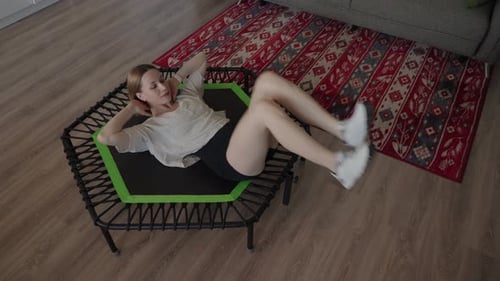 Woman Exercising on a Trampoline in Her Home