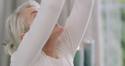 Senior Woman Meditating with Hands in Prayer