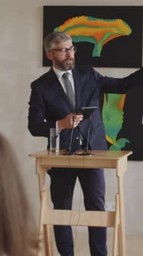 Corporate Man Presents at Art Auction