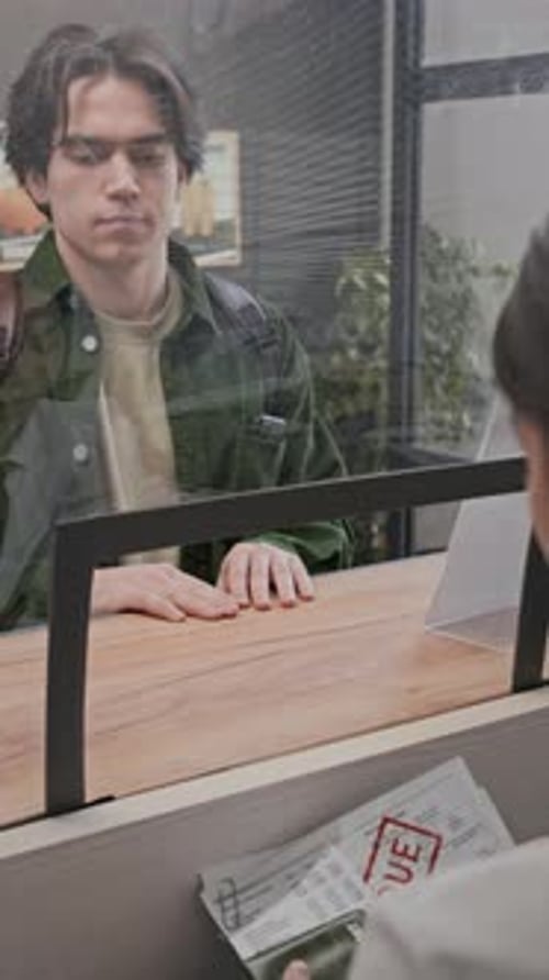 Young Man Receives Past Due Bill from Teller