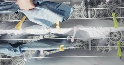 Hanging Wet Clothes on Clothesline Indoors