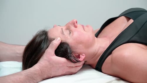 Woman Receives Relaxing Neck Massage at Medical Appointment
