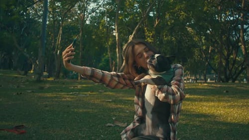Woman Taking Selfie with Dog in Green Park