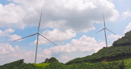 Wind Turbines Turning on Green Hillside