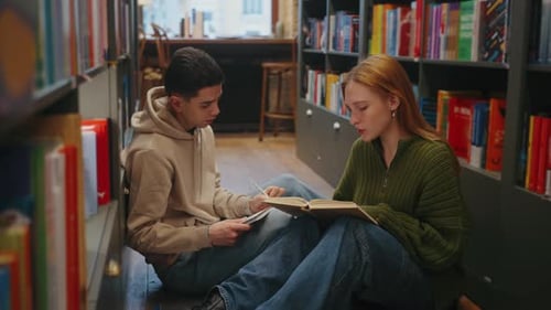 Students Studying Together on Library Floor