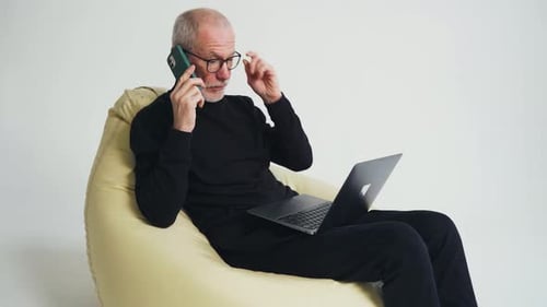 Senior Man Working from Home on Laptop