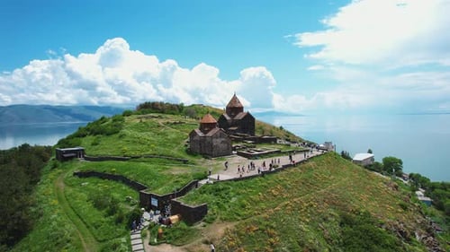 Aerial view monastery on mountain. Drone fly to ancient church Sevanavank in Armenia, Caucasus.