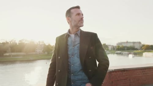 Man walking along the embankment of the river