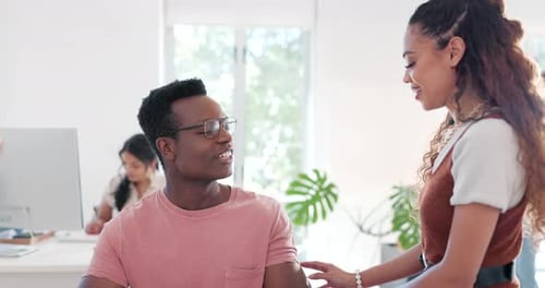 Office, conversation and woman flirting with a man at his desk while working on a project