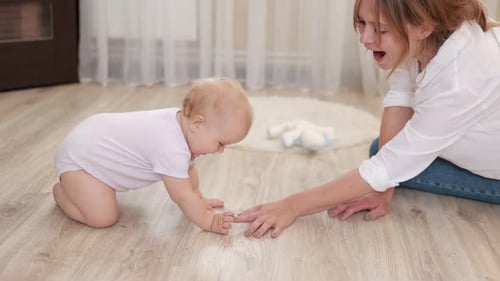 Adorable Baby Crawling Towards Mother on Floor