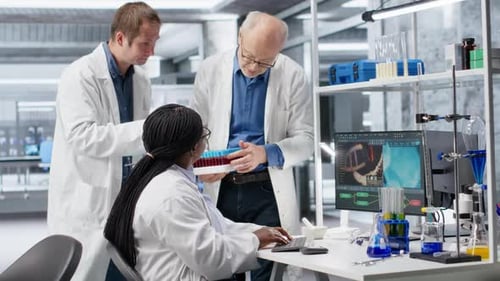 Scientists Team Handles Blood Samples in Test Tube Within Laboratory