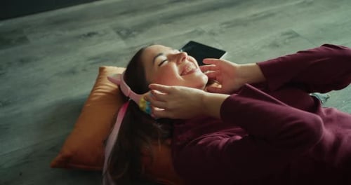 Smiling Woman Listening to Music with Headphones