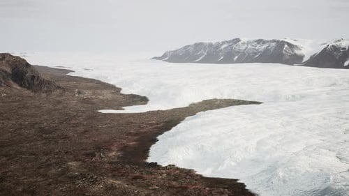 A Snowy Landscape with Majestic Mountains in the Distance