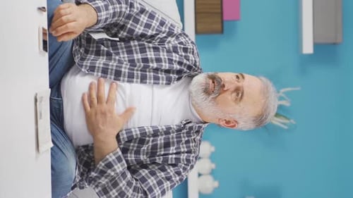 Vertical video of Old man with nausea.