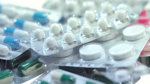 Pharmaceutical Pills Package. Medical Drugs Background. Headache Tablets. Pharmacy Industry. Medicam