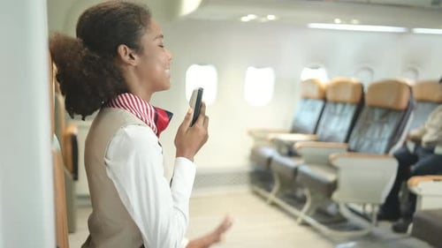 Flight attendant speaking through a loudspeaker to welcome passengers