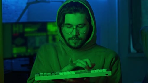 Programmer Ironically and Inappropriately Types the Code on the Keyboard He Looks Directly Into the